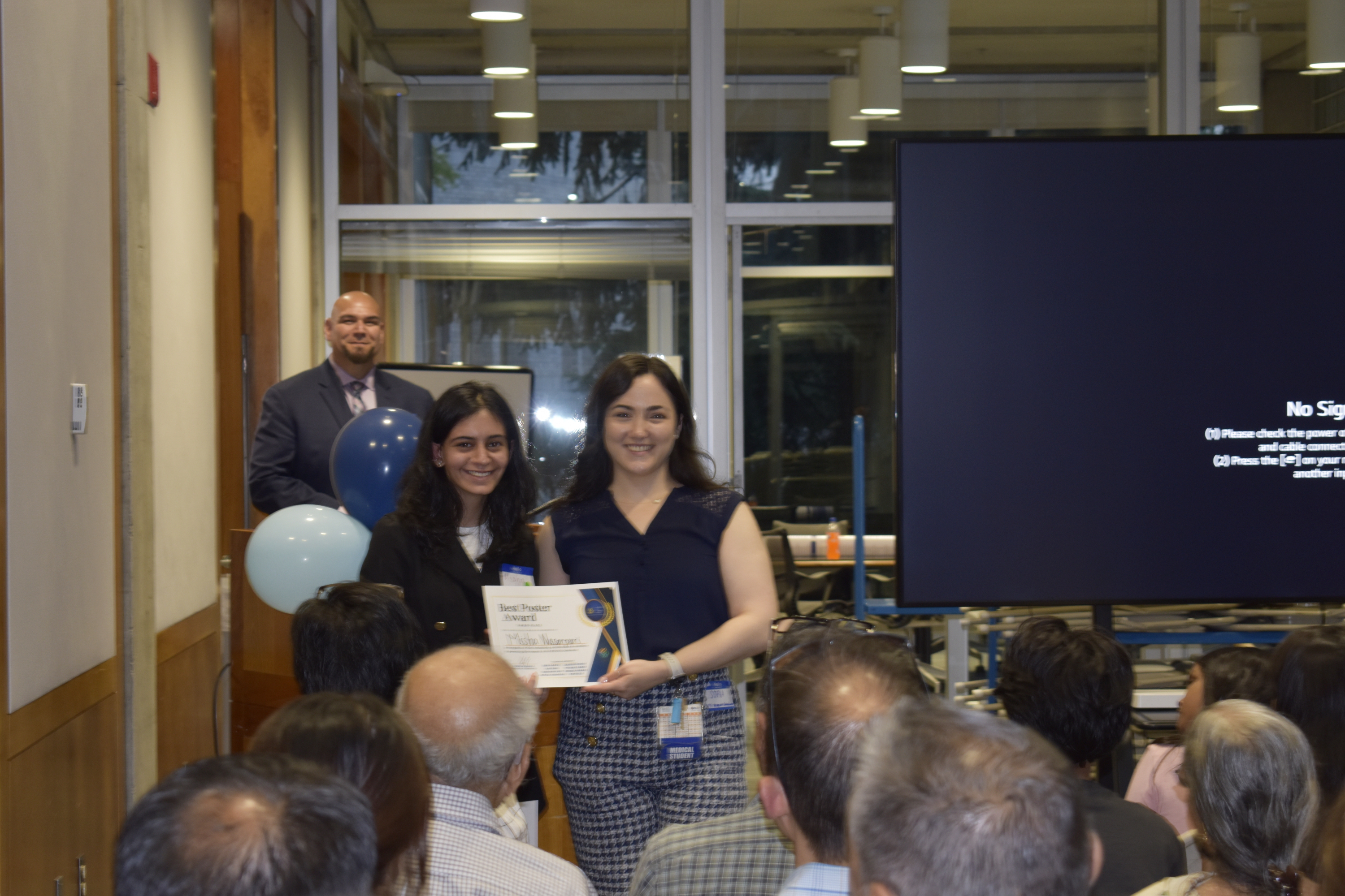 Misha receiving best poster (third place) award alongside Sofia (PSI director) and Dr. Barajas.