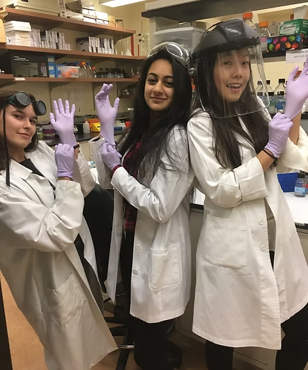 PSI students wearing laboratory coats and protective equipment
